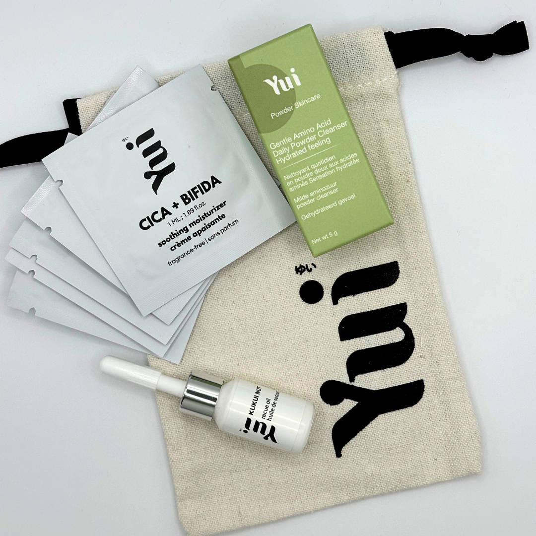 Discovery Kit by Yui Skin featuring travel-size cleanser, oil, and moisturizer in a branded pouch. Ideal for sensitive skin and on-the-go skincare.
