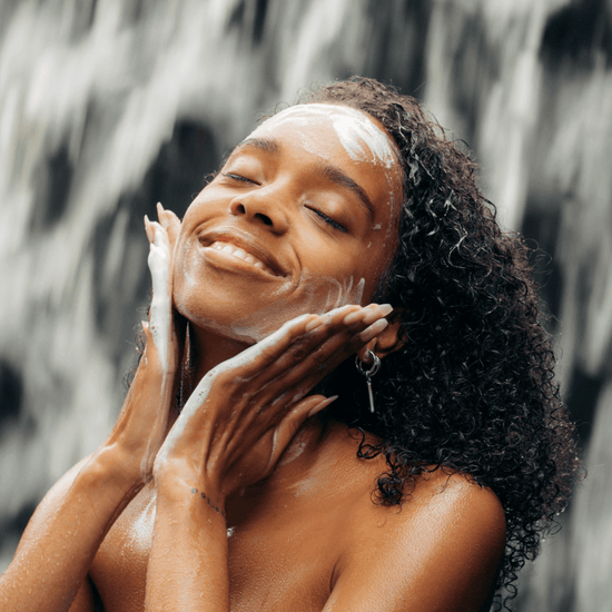 Woman enjoying Yui Powder Cleanser with foamy face