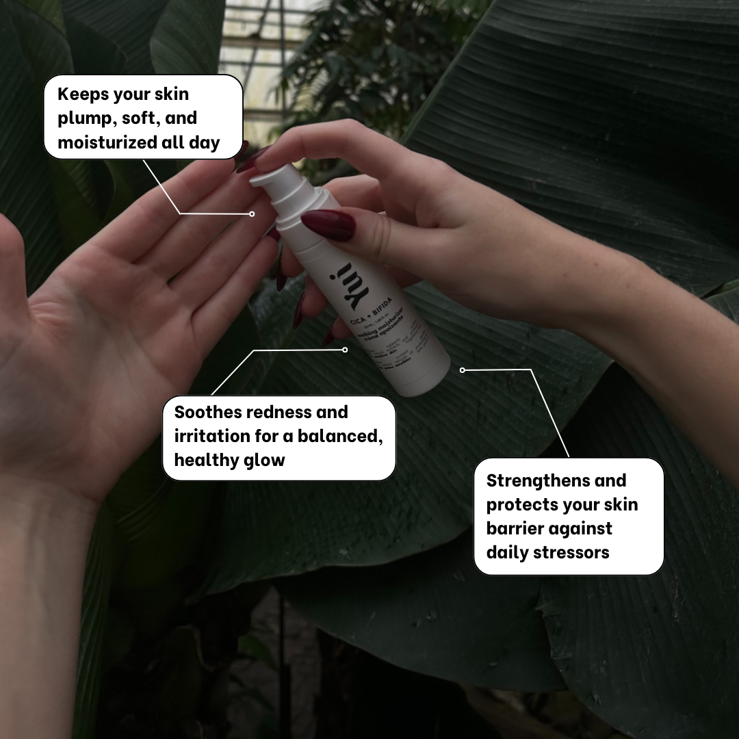 Cica + Bifida Soothing Moisturizer being applied to hands against a lush green background. Highlights benefits like hydration, soothing redness, and strengthening the skin barrier.
